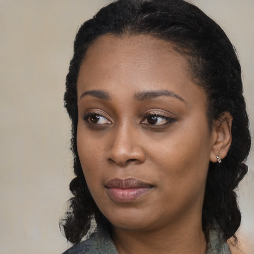 Joyful black young-adult female with medium  black hair and brown eyes
