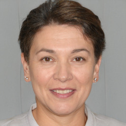 Joyful white adult female with short  brown hair and brown eyes