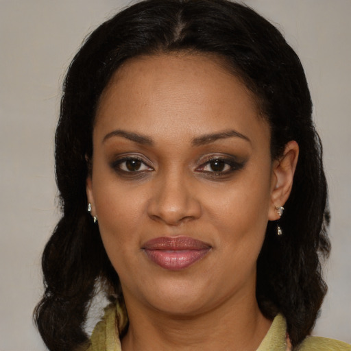 Joyful black young-adult female with medium  brown hair and brown eyes