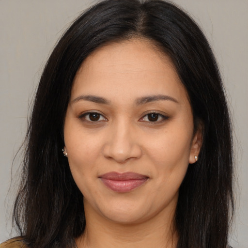 Joyful latino young-adult female with long  brown hair and brown eyes