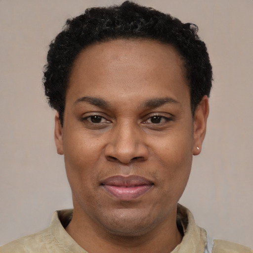 Joyful latino adult male with short  black hair and brown eyes