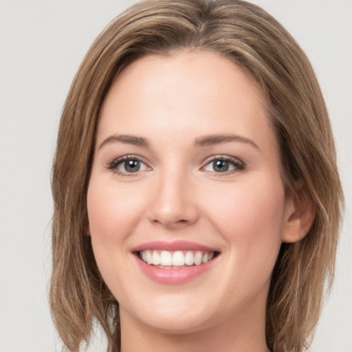 Joyful white young-adult female with long  brown hair and green eyes