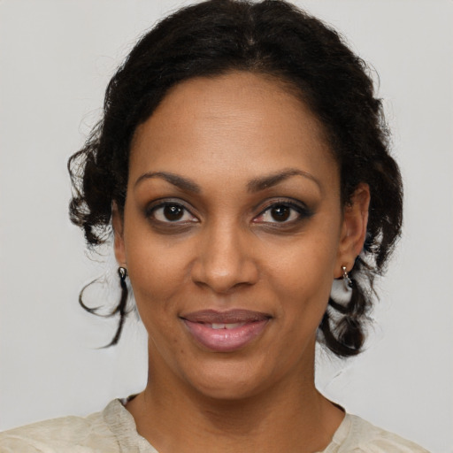 Joyful black young-adult female with medium  brown hair and brown eyes