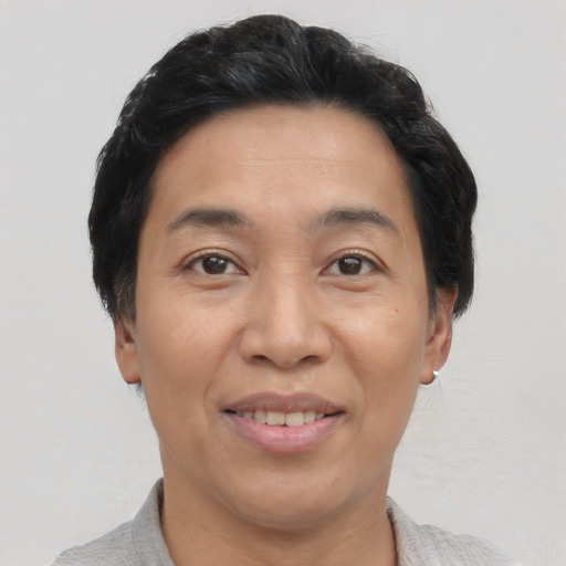 Joyful asian adult female with short  brown hair and brown eyes