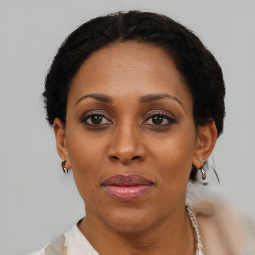 Joyful black adult female with short  brown hair and brown eyes
