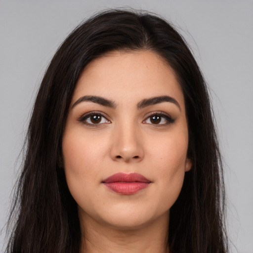 Joyful latino young-adult female with long  brown hair and brown eyes