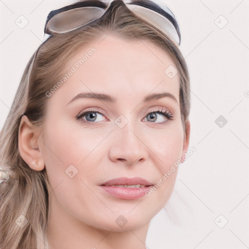 Joyful white young-adult female with long  brown hair and blue eyes