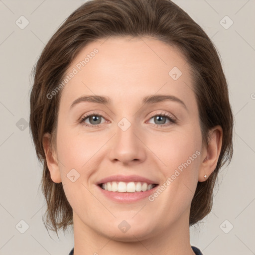 Joyful white young-adult female with medium  brown hair and green eyes