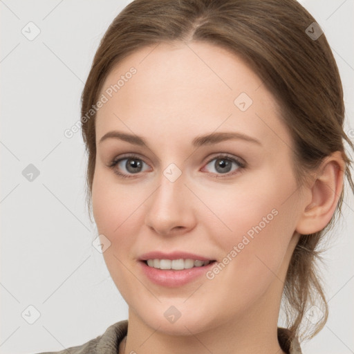 Joyful white young-adult female with medium  brown hair and grey eyes