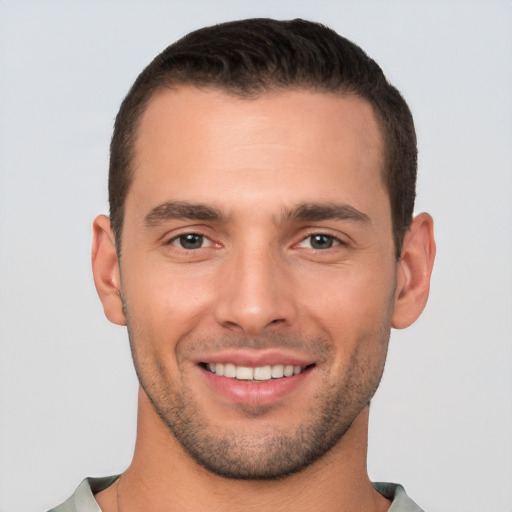 Joyful white young-adult male with short  brown hair and brown eyes