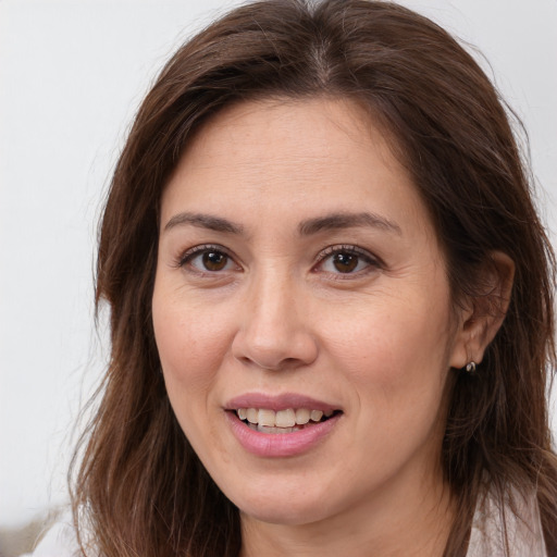 Joyful white adult female with long  brown hair and brown eyes