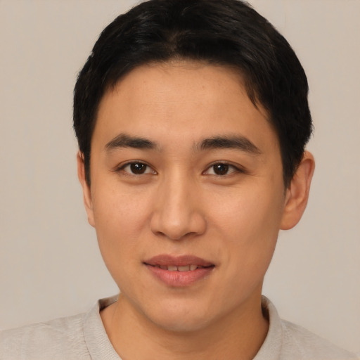 Joyful asian young-adult male with short  brown hair and brown eyes