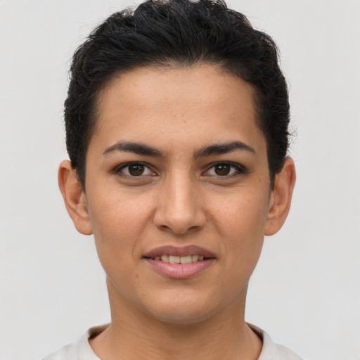 Joyful latino young-adult female with short  brown hair and brown eyes