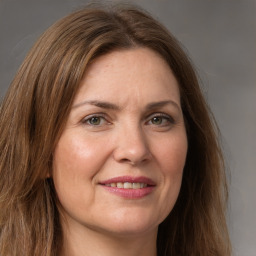 Joyful white adult female with medium  brown hair and grey eyes