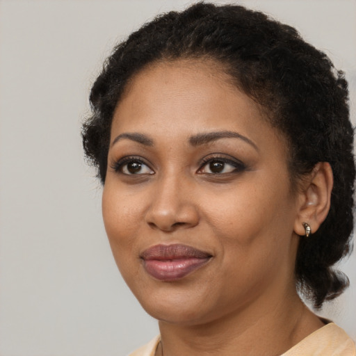 Joyful black young-adult female with medium  brown hair and brown eyes