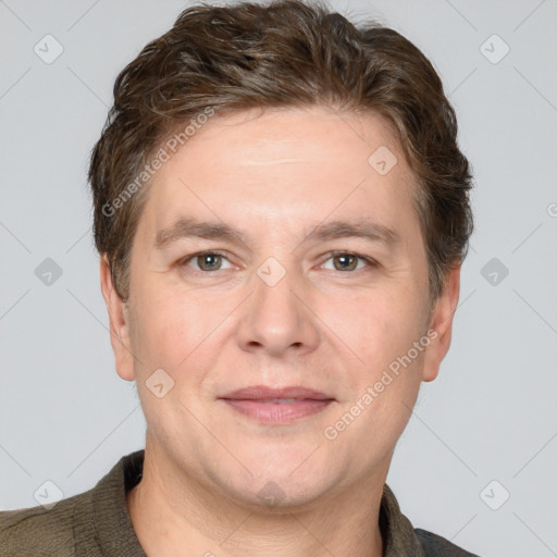 Joyful white adult male with short  brown hair and grey eyes