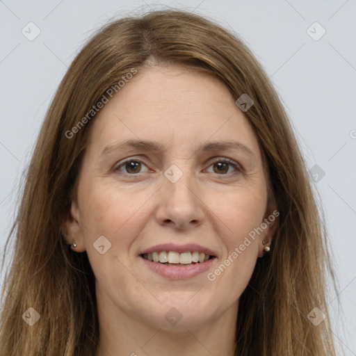 Joyful white adult female with long  brown hair and grey eyes