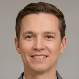 Joyful white adult male with short  brown hair and grey eyes