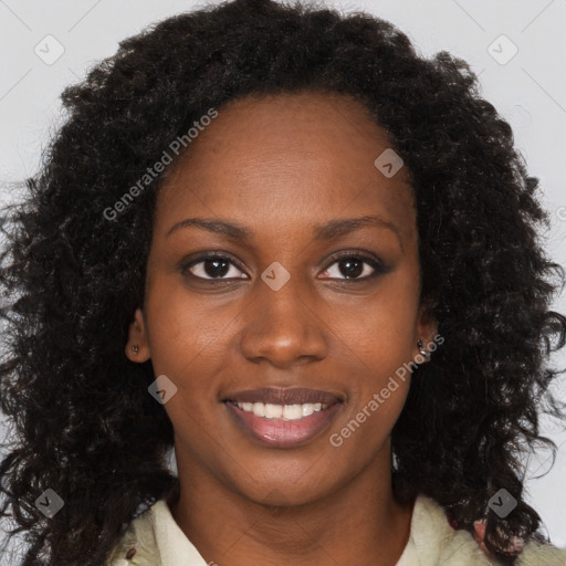 Joyful black young-adult female with long  brown hair and brown eyes