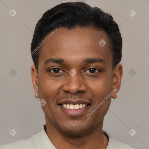 Joyful black young-adult male with short  black hair and brown eyes