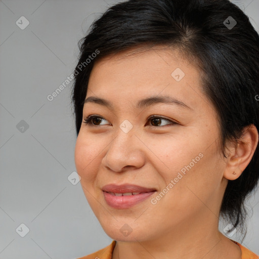 Joyful asian adult female with medium  brown hair and brown eyes