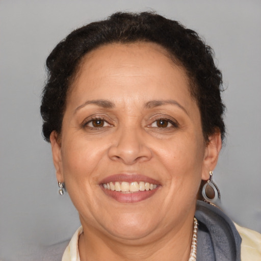 Joyful latino adult female with short  brown hair and brown eyes