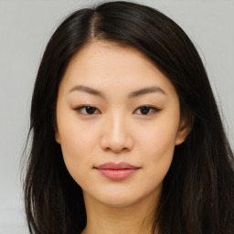 Joyful asian young-adult female with long  brown hair and brown eyes