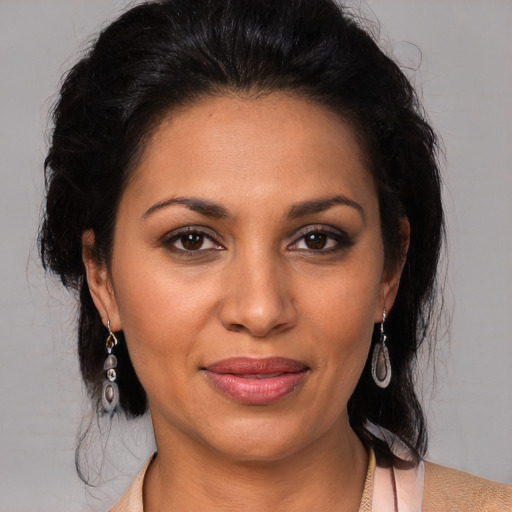 Joyful black adult female with medium  brown hair and brown eyes