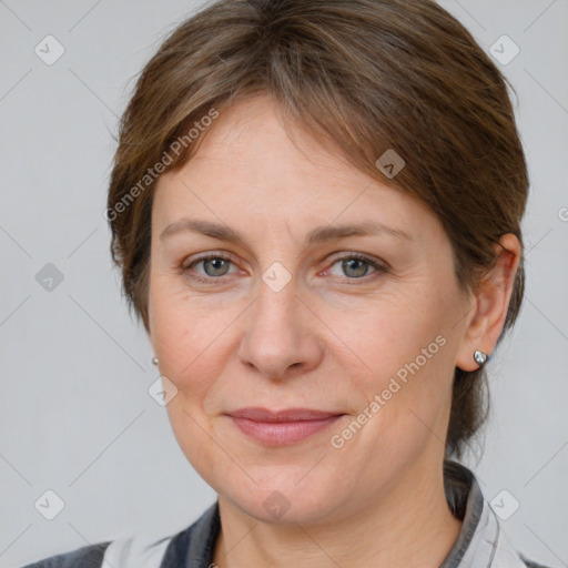 Joyful white adult female with medium  brown hair and grey eyes