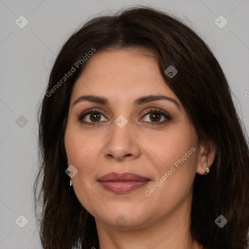 Joyful white adult female with long  brown hair and brown eyes