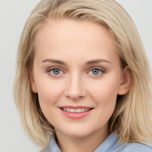 Joyful white young-adult female with medium  brown hair and blue eyes