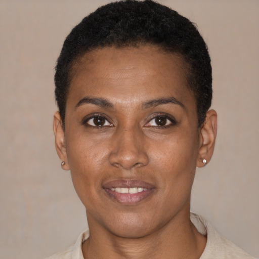 Joyful black young-adult female with short  black hair and brown eyes