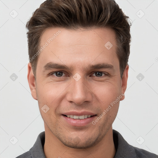 Joyful white young-adult male with short  brown hair and grey eyes