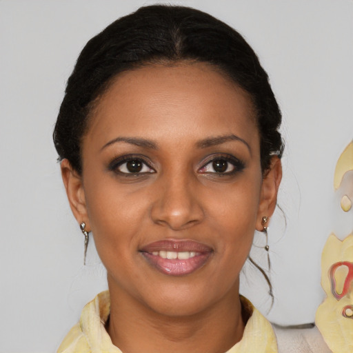 Joyful black young-adult female with medium  brown hair and brown eyes