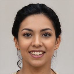 Joyful latino young-adult female with medium  brown hair and brown eyes