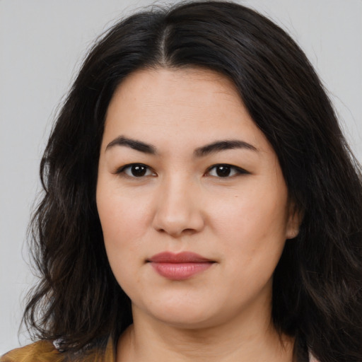 Joyful asian young-adult female with long  brown hair and brown eyes