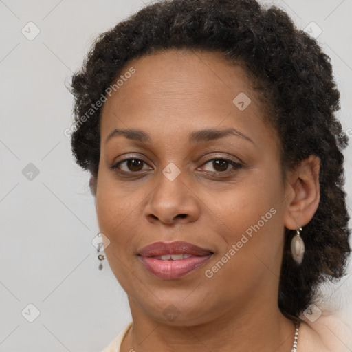 Joyful black adult female with short  brown hair and brown eyes