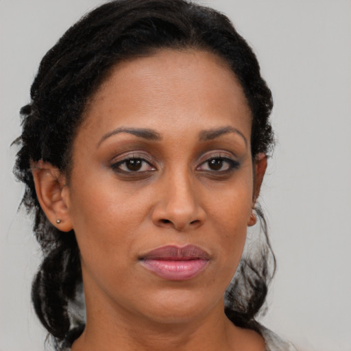 Joyful black young-adult female with medium  brown hair and brown eyes