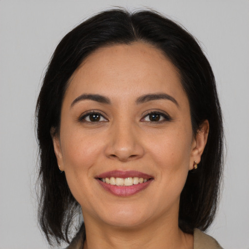 Joyful latino young-adult female with medium  brown hair and brown eyes