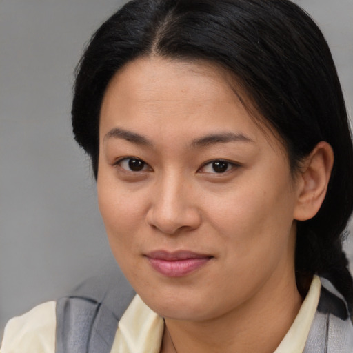 Joyful asian young-adult female with short  brown hair and brown eyes