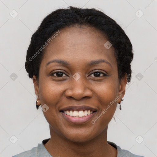 Joyful black young-adult female with short  black hair and brown eyes