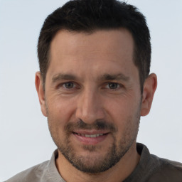 Joyful white adult male with short  brown hair and brown eyes