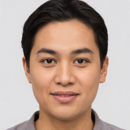 Joyful asian young-adult male with short  brown hair and brown eyes