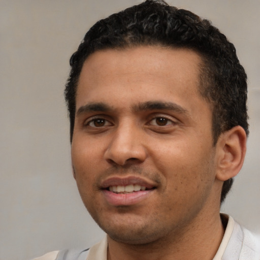 Joyful white young-adult male with short  black hair and brown eyes