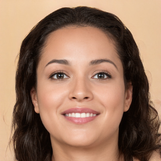 Joyful white young-adult female with long  brown hair and brown eyes