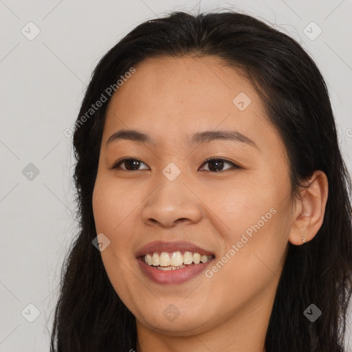 Joyful asian young-adult female with long  brown hair and brown eyes