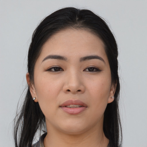 Joyful asian young-adult female with long  brown hair and brown eyes