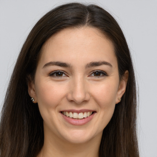 Joyful white young-adult female with long  brown hair and brown eyes