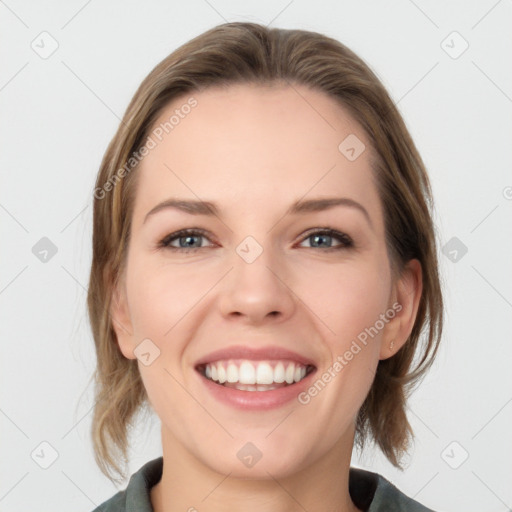 Joyful white young-adult female with medium  brown hair and grey eyes