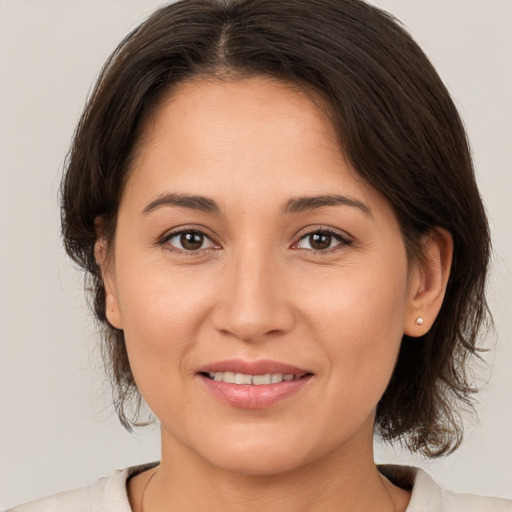 Joyful white young-adult female with medium  brown hair and brown eyes